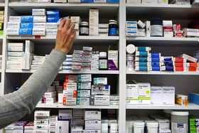 A pharmacist stocks shelves at a chemist. PIC: Julien Behal/PA Wire