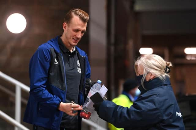 Dan Burn of Newcastle United has their Covid-19 certification scanned as he arrives at the stadium prior to the Premier League match between Newcastle United  and  Everton at St. James Park on February 08, 2022 in Newcastle upon Tyne, England. (Photo by Stu Forster/Getty Images)
