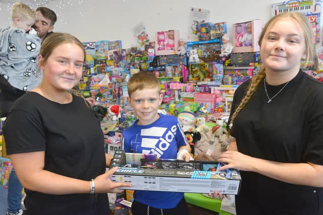 Hope 4 Kidz volunteers Sophie Wimsett and Amber Scott  at Sunderland Royal Hospital handing over toys from Christmas appeal to Jayden Pearson.