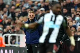 Newcastle United head coach Eddie Howe watches Allan Saint-Maximin from the dugout.