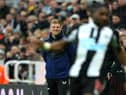Newcastle United head coach Eddie Howe watches Allan Saint-Maximin from the dugout.