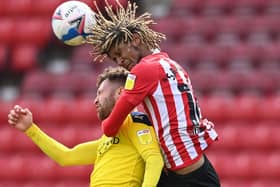 Oxford player Matt Taylor is challenged by Dion Sanderson of Sunderland during the Sky Bet League One match between Sunderland and Oxford United at Stadium of Light on April 02, 2021 in Sunderland, England.
