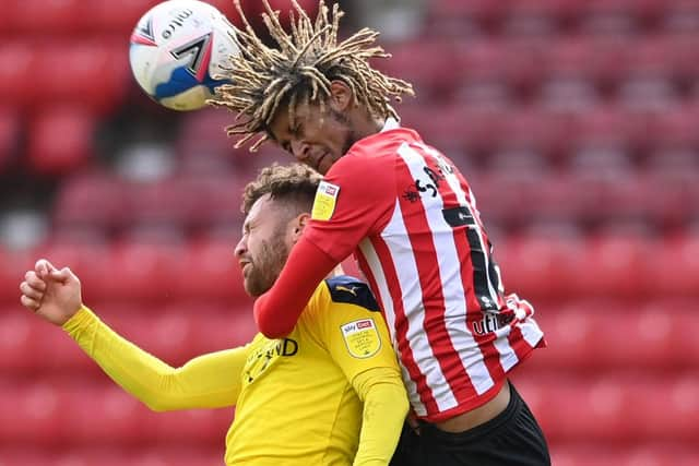 Oxford player Matt Taylor is challenged by Dion Sanderson of Sunderland during the Sky Bet League One match between Sunderland and Oxford United at Stadium of Light on April 02, 2021 in Sunderland, England.