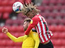 Oxford player Matt Taylor is challenged by Dion Sanderson of Sunderland during the Sky Bet League One match between Sunderland and Oxford United at Stadium of Light on April 02, 2021 in Sunderland, England.