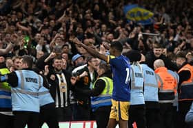 Newcastle United's Swedish striker Alexander Isak (C) celebrates with supporters after the English Premier League football match between Nottingham Forest and Newcastle United at The City Ground in Nottingham, central England, on March 17, 2023. - Newcastle won the game 2-1. (Photo by Oli SCARFF / AFP)