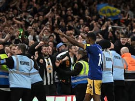 Newcastle United's Swedish striker Alexander Isak (C) celebrates with supporters after the English Premier League football match between Nottingham Forest and Newcastle United at The City Ground in Nottingham, central England, on March 17, 2023. - Newcastle won the game 2-1. (Photo by Oli SCARFF / AFP)