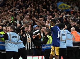 Newcastle United's Swedish striker Alexander Isak (C) celebrates with supporters after the English Premier League football match between Nottingham Forest and Newcastle United at The City Ground in Nottingham, central England, on March 17, 2023. - Newcastle won the game 2-1. (Photo by Oli SCARFF / AFP)