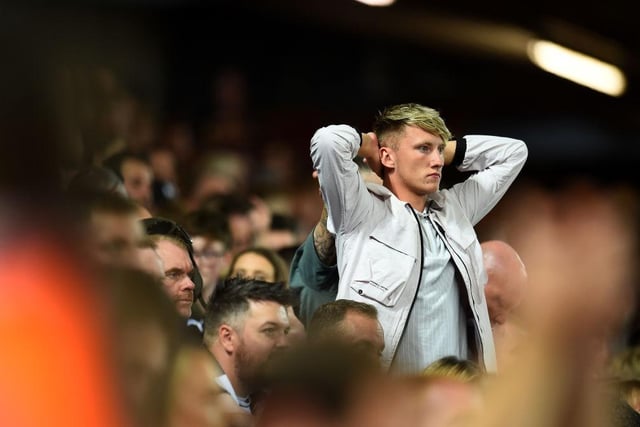 One fan watches on in disbelief as Liverpool snatch a win from nowhere in added on added time (Photo by Andrew Powell/Liverpool FC via Getty Images)