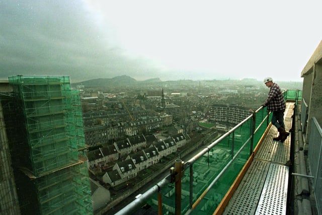 Demolition expert Rob Morgan makes the most of the dramatic view of the capital from his 210 foot high scaffold vantage point on about-to-be-demolished high rises Cairngorm House and Grampian House in Leith. Picture taken in 1997.