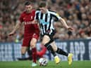 Newcastle United's English midfielder Elliot Anderson (R) vies with Liverpool's English midfielder James Milner (L) during the English Premier League football match between Liverpool and Newcastle United at Anfield in Liverpool, north west England on August 31, 2022. (Photo by PAUL ELLIS/AFP via Getty Images)
