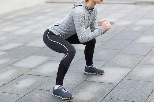 “Before you squat, you should get in position.That means keeping your feet about shoulder-width apart.” 