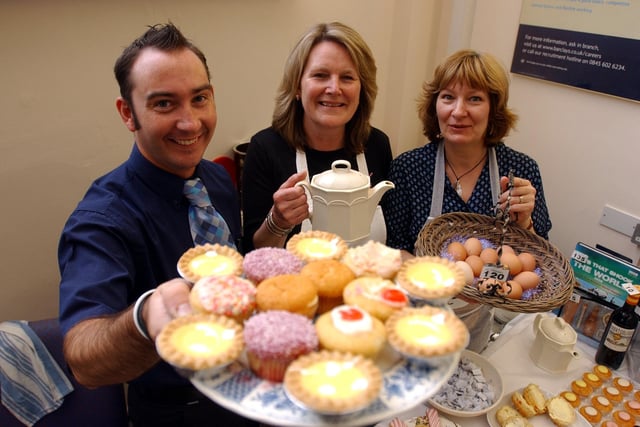 John Symons, Marion King and Jan MacLachlan enjoyed a cuppa and cake for charity at Barclays in King Street 18 years ago.