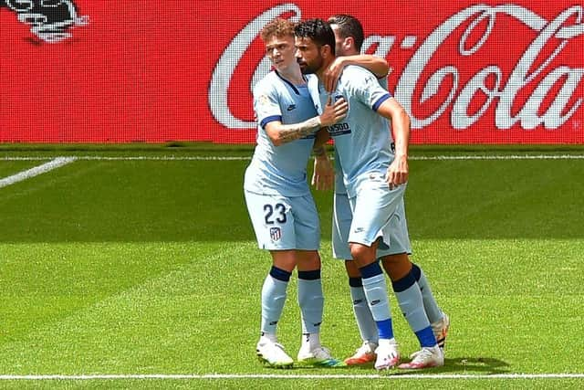 Atletico Madrid's Spanish forward Diego Costa (C) celebrates with Atletico Madrid's Spanish midfielder Koke and Atletico Madrid's English defender Kieran Trippier after scoring during the Spanish League football match between Athletic Club Bilbao and Club Atletico de Madrid at the San Mames stadium in Bilbao on June 14, 2020. (Photo by ANDER GILLENEA / AFP)