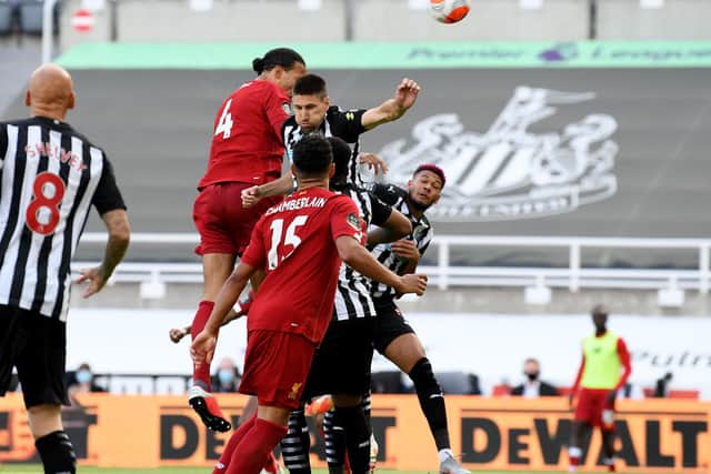 The players compete for the ball at St James's Park.