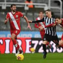 Miguel Almiron of Newcastle United is challenged by Jan Bednarek of Southampton (Photo by Gareth Copley/Getty Images)