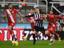 Miguel Almiron of Newcastle United is challenged by Jan Bednarek of Southampton (Photo by Gareth Copley/Getty Images)