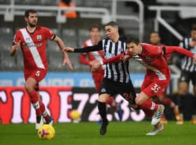Miguel Almiron of Newcastle United is challenged by Jan Bednarek of Southampton (Photo by Gareth Copley/Getty Images)