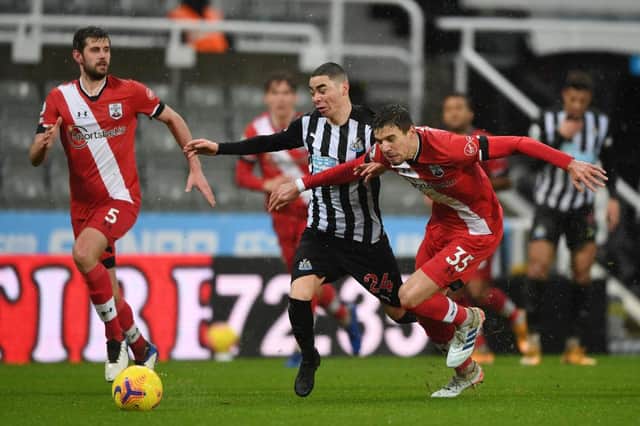 Miguel Almiron of Newcastle United is challenged by Jan Bednarek of Southampton (Photo by Gareth Copley/Getty Images)