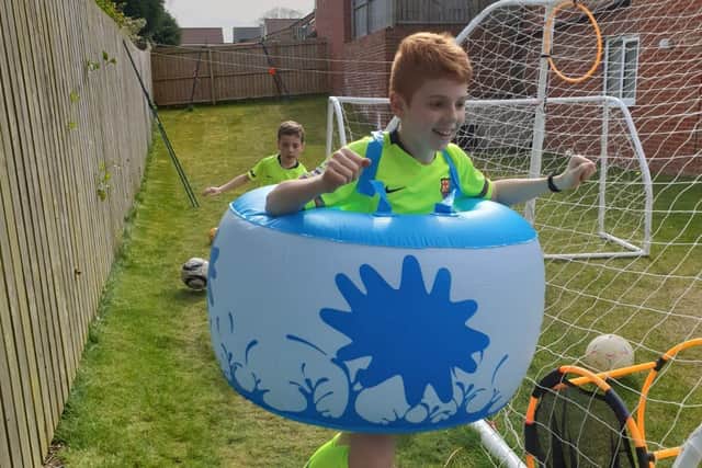 Charlie completes his laps in his Zorb bodysuit.