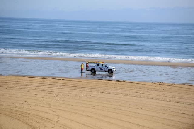A dad was rescued by lifeguards and a surfer after being swept out to sea in South Shields.