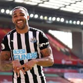 Callum Wilson of Newcastle United celebrates after scoring a goal which was later disallowed due to a handball during the Premier League match between Liverpool and Newcastle United at Anfield on April 24, 2021 in Liverpool, England.