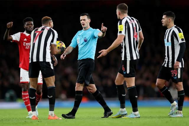 Newcastle United's Joelinton, left, protests to referee Andy Madley.