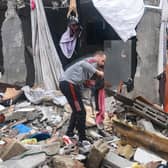 A Palestinian man inspects the damages amid the rubble following Israeli bombardment in Rafah in the southern Gaza Strip as battles continue. Photo by Mohammed Abed/AFP via Getty Images