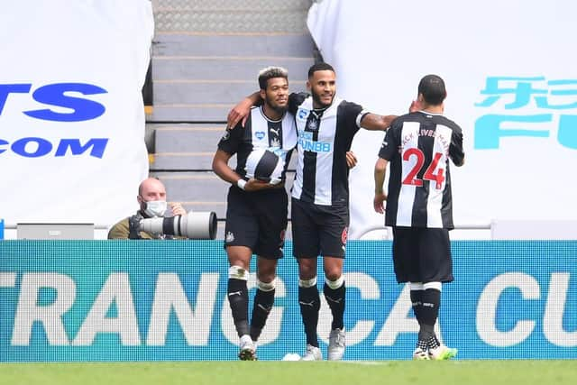 Joelinton, left, celebrates his goal.