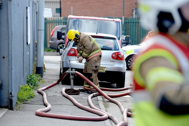 A firefighter accessing a water supply to operate the hose reel jets.