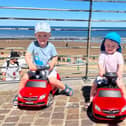 Elijah and Tommy driving their cars