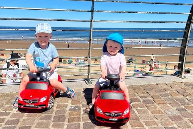 Elijah and Tommy driving their cars