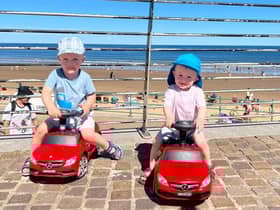 Elijah and Tommy driving their cars