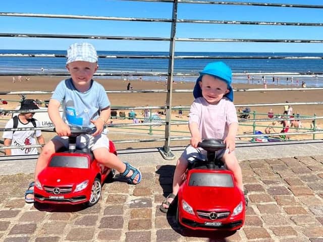 Elijah and Tommy driving their cars