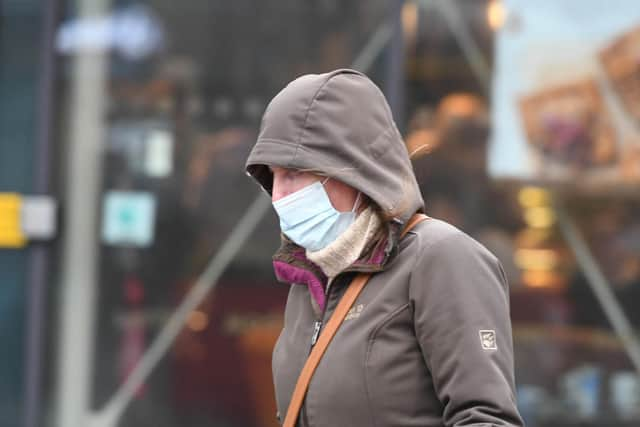 A file picture of a passerby in a mask as concerns are raised over the level of covid infection in the North East.