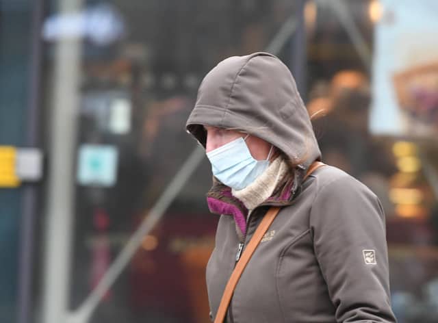 A file picture of a passerby in a mask as concerns are raised over the level of covid infection in the North East.