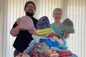 Revd Jason Wratten and Judith Jackson from the Knit and Craft Group with 100 hats for babies and young children.