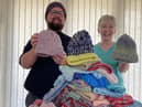 Revd Jason Wratten and Judith Jackson from the Knit and Craft Group with 100 hats for babies and young children.