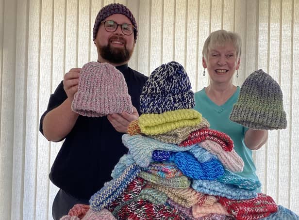 Revd Jason Wratten and Judith Jackson from the Knit and Craft Group with 100 hats for babies and young children.