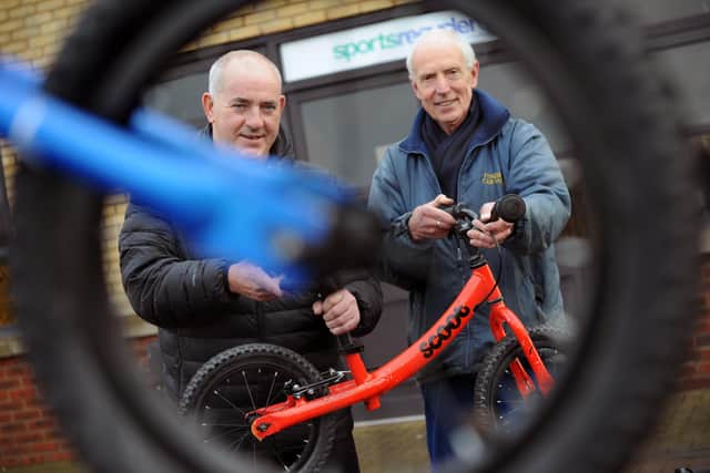 South Tyneside Council Councillor, Ernest Gibson (left), with Sports Recycler's Workshop Manager, Keith Thompson, and one of the donated balance bikes.