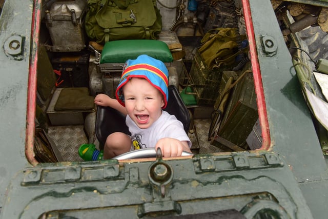 Kristian Cavanagh, aged three, explores an armoured car at the Armed Forces Day event.