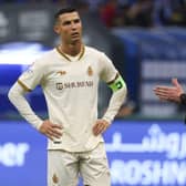 Cristiano Ronaldo listens to referee Michael Oliver during the Saudi Pro League football match between Al-Hilal and Al-Nassr in Riyadh.