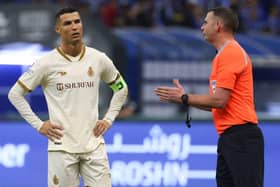 Cristiano Ronaldo listens to referee Michael Oliver during the Saudi Pro League football match between Al-Hilal and Al-Nassr in Riyadh.