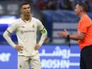 Cristiano Ronaldo listens to referee Michael Oliver during the Saudi Pro League football match between Al-Hilal and Al-Nassr in Riyadh.