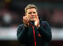 Eddie Howe applauds fans at the Emirates Stadium.