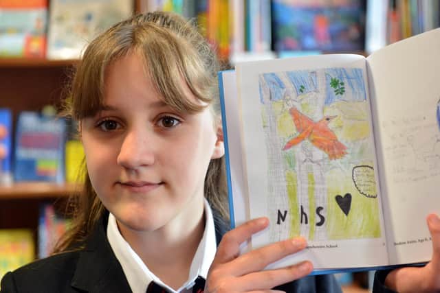Hebburn Comprehensive School pupil Christina O'Brien, 12, holding a copy of her painting which has been included in the recently published "Thank You NHS" book.