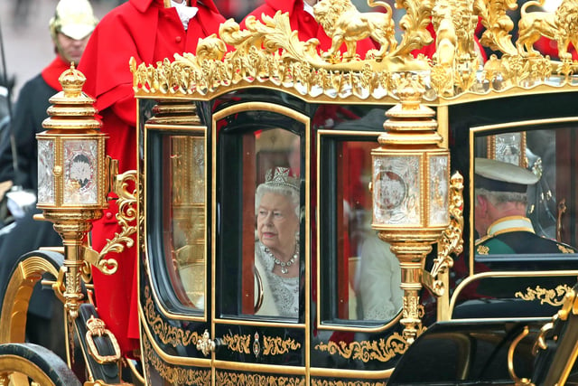 Queen Elizabeth II, accompanied by the Duke and Duchess of Cornwall, returning to Buckingham Palace, London, in the Diamond Jubilee State Coach, having delivered The Queen's Speech. 14/10/19