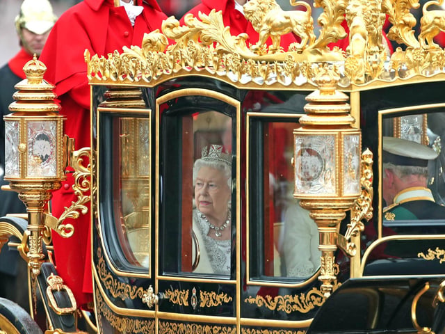 Queen Elizabeth II, accompanied by the Duke and Duchess of Cornwall, returning to Buckingham Palace, London, in the Diamond Jubilee State Coach, having delivered The Queen's Speech. 14/10/19