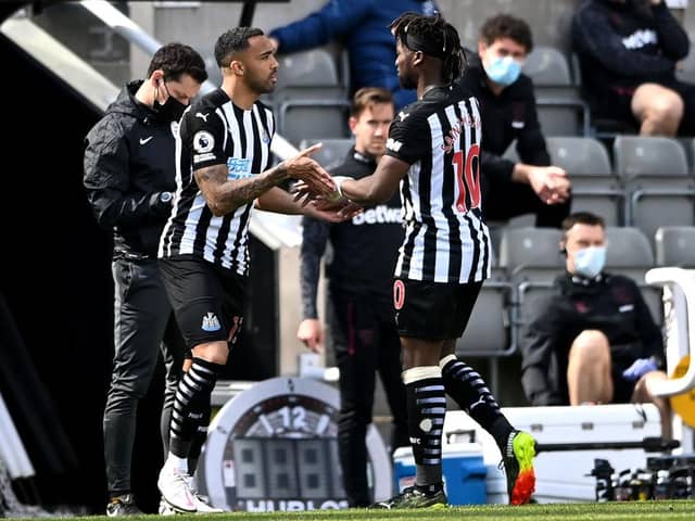 Callum Wilson of Newcastle United is substituted on for Allan Saint-Maximin  during the Premier League match between Newcastle United and West Ham United at St. James Park on April 17, 2021 in Newcastle upon Tyne, England.