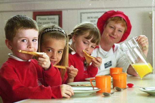 The breakfast club at Barnes School in 1999.  Pictured left to right are Paul Collins, five; Tania Abidi, six; Bethany Longville, five; and school cook Julie Davison.