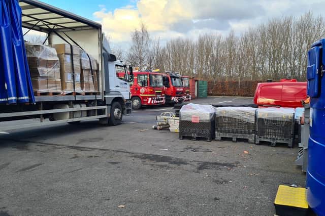 Staff at Tony Carter Transport Limited loading fire equipment onto lorry at TWFRS Stores warehouse